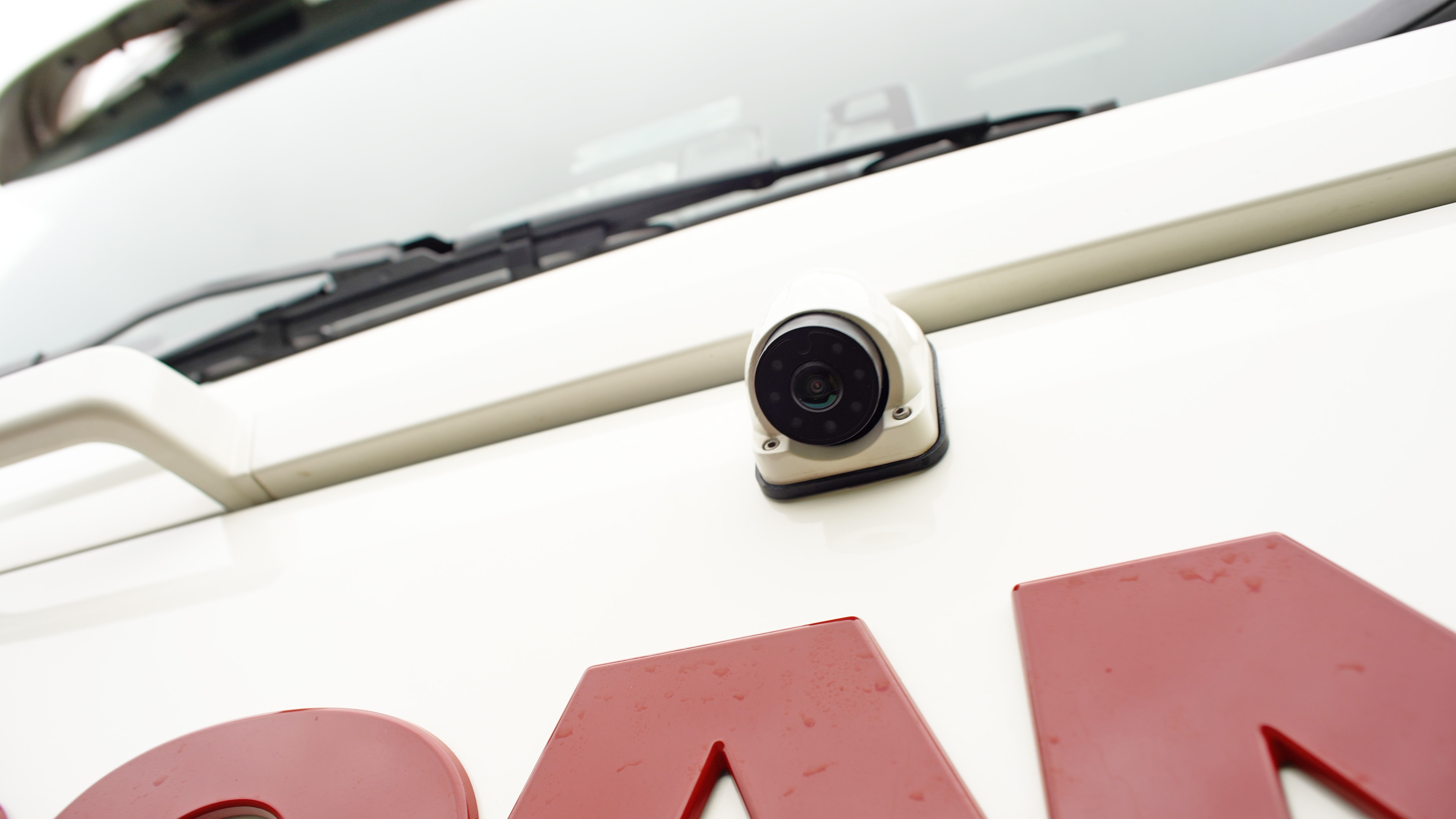 Close-up of a Fastview360 MOIS side camera fitted to a white commercial vehicle